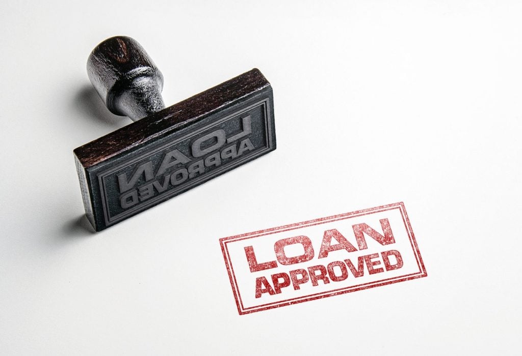 Rubber,Stamping,That,Says,'loan,Approved'.